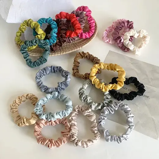 Close-up of a 1cm pure silk scrunchie with smooth silk surface and seamless hand-stitching
