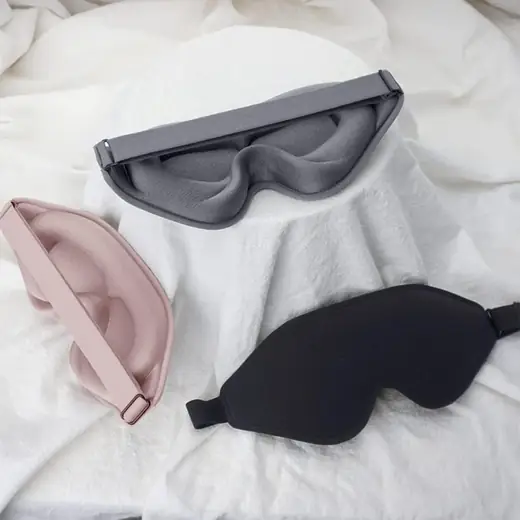 3D silk sleeping eye mask laid flat showing the cup-shaped design and reinforced stitching