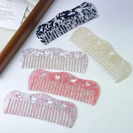 Cellulose acetate round tooth comb with a crystal-like finish laid flat