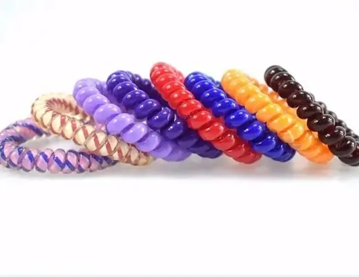 Spiral TPU hair tie laid flat showing the coil structure