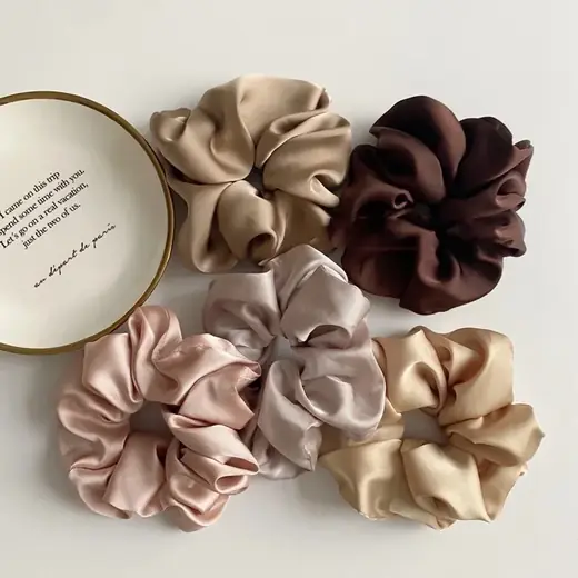 Close-up of a handmade microfiber hair scrunchie with visible hand-stitched seams