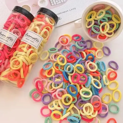 A set of high quality elastic hair ties laid out in various custom shapes and colours