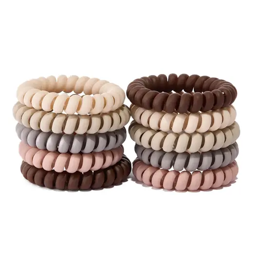 Spiral-shaped TPU hair tie laid flat showing the coiled structure
