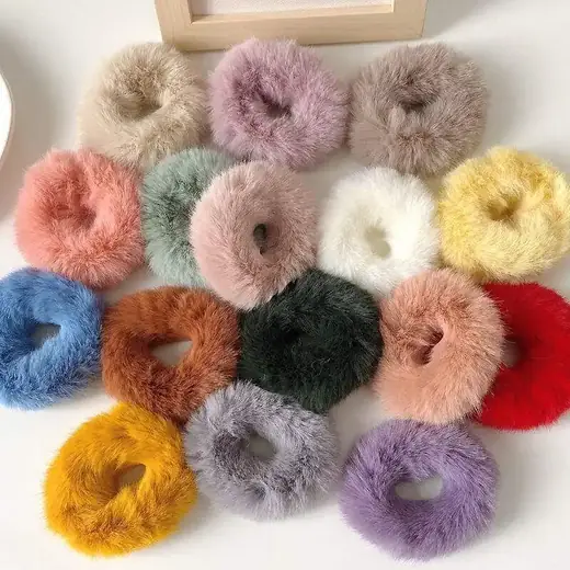 Set of plush rabbit fur hair scrunchies laid out flat showing the soft fabric surface