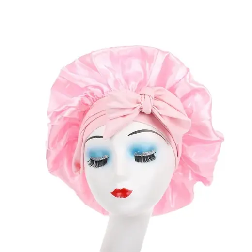 Satin bonnet laid flat showing the adjustable tie band and smooth fabric surface