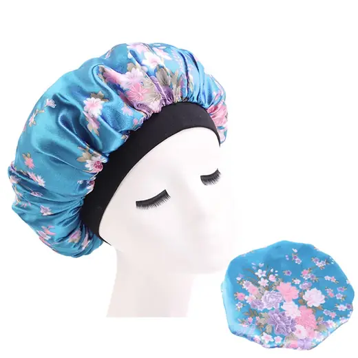 Satin hair bonnet with wide elastic band laid flat, showing the smooth fabric surface