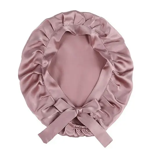 Silk hair bonnet with adjustable ribbons laid flat, showing double-layer construction