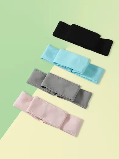 Black sport headband laid flat showing seamless front and flatlock stitching