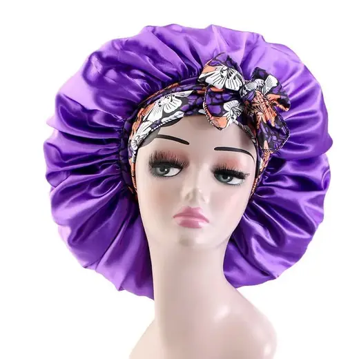 Satin bonnet with floral print laid out flat, showing the two wide bands and double-layer construction