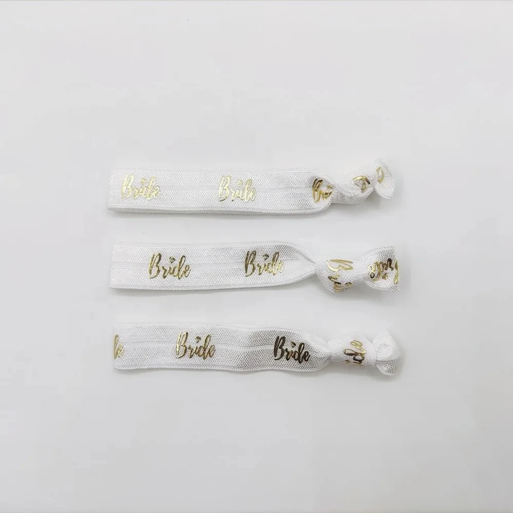 Hair tie with custom logo printed on the band, placed on a white background