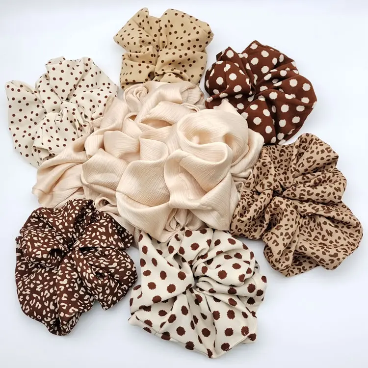Set of fabric hair scrunchies in solid colours laid out flat
