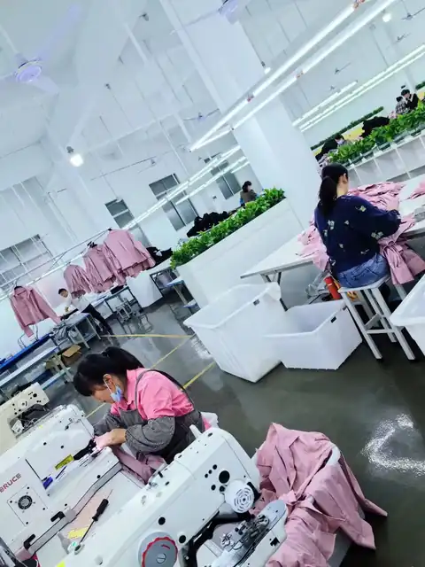 Sewing line at the Joyue Fashion factory in Guangzhou stitching a pink outerwear order