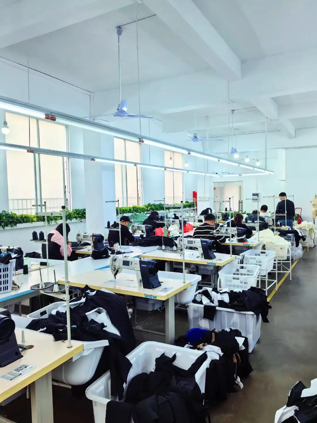 Brother lockstitch machines and cut bundles on the Joyue Fashion production floor
