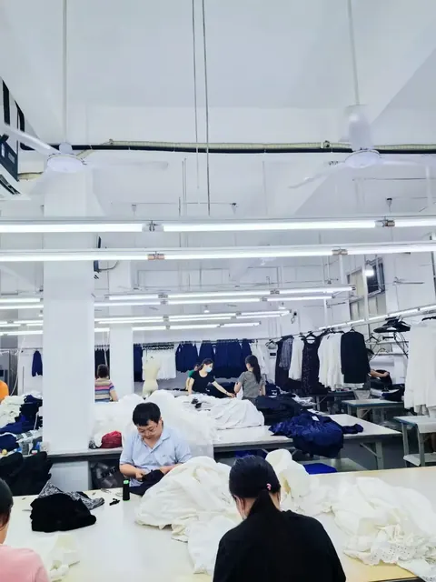Finishing and hanging area with cut panels and sample garments on rails