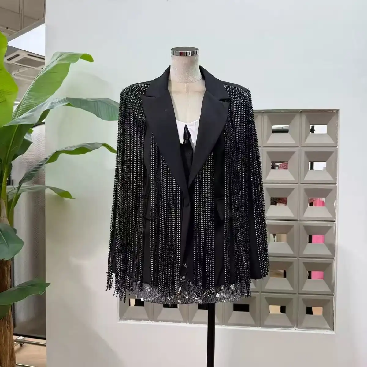 Black tailored blazer covered in crystal chain fringe with notch lapels