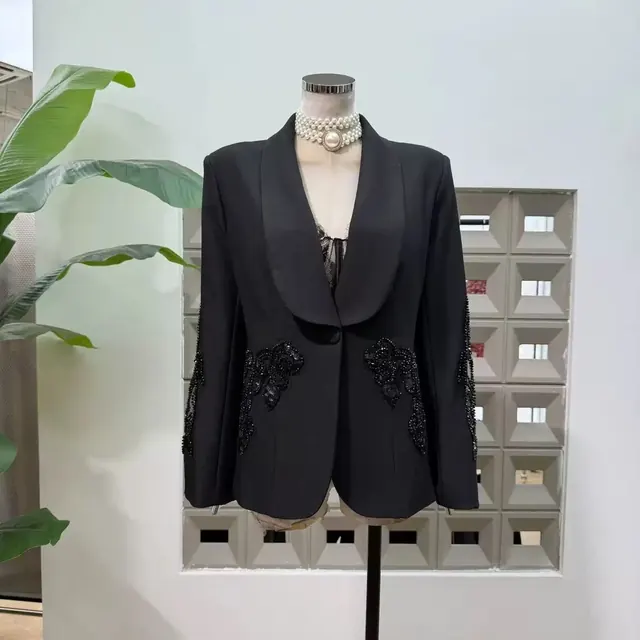 Black shawl collar blazer with black beaded applique at the hip and sleeves