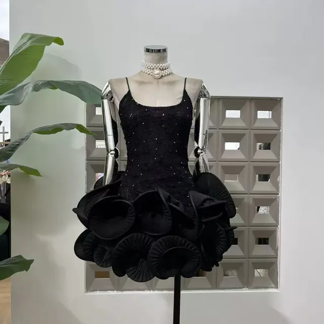 Black beaded lace mini dress with sculptural circular rosette hem