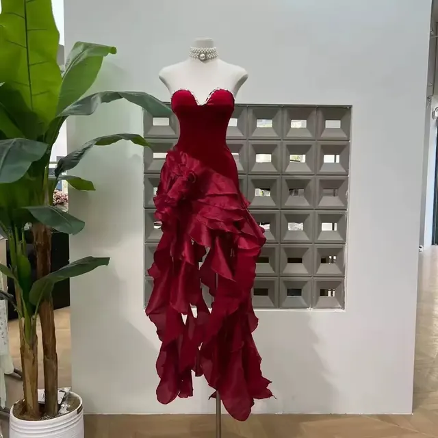 Red velvet sweetheart bustier gown with cascading organza ruffles