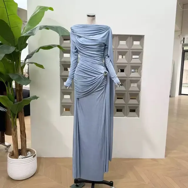 Dusty blue draped jersey column gown with long sleeves and a gathered waist