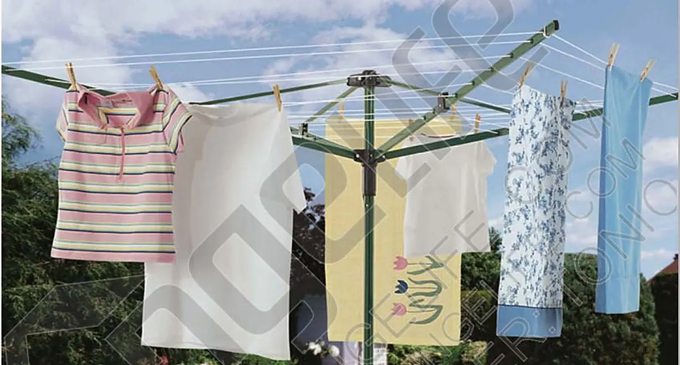 Washing hanging on a four-arm rotary airer in a suburban back garden