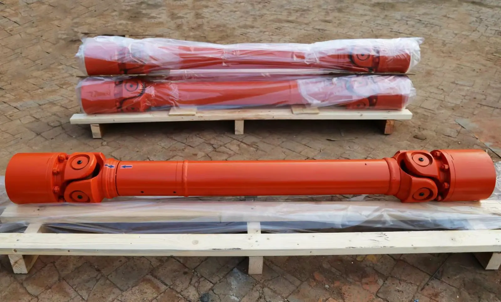 Heavy duty industrial drive shafts wrapped and strapped to a pallet