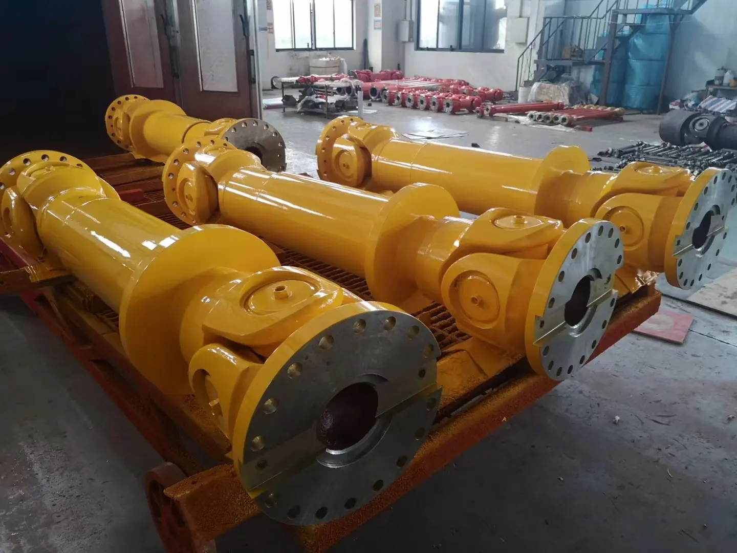 Finished heavy duty propeller shafts staged on a pallet before packing