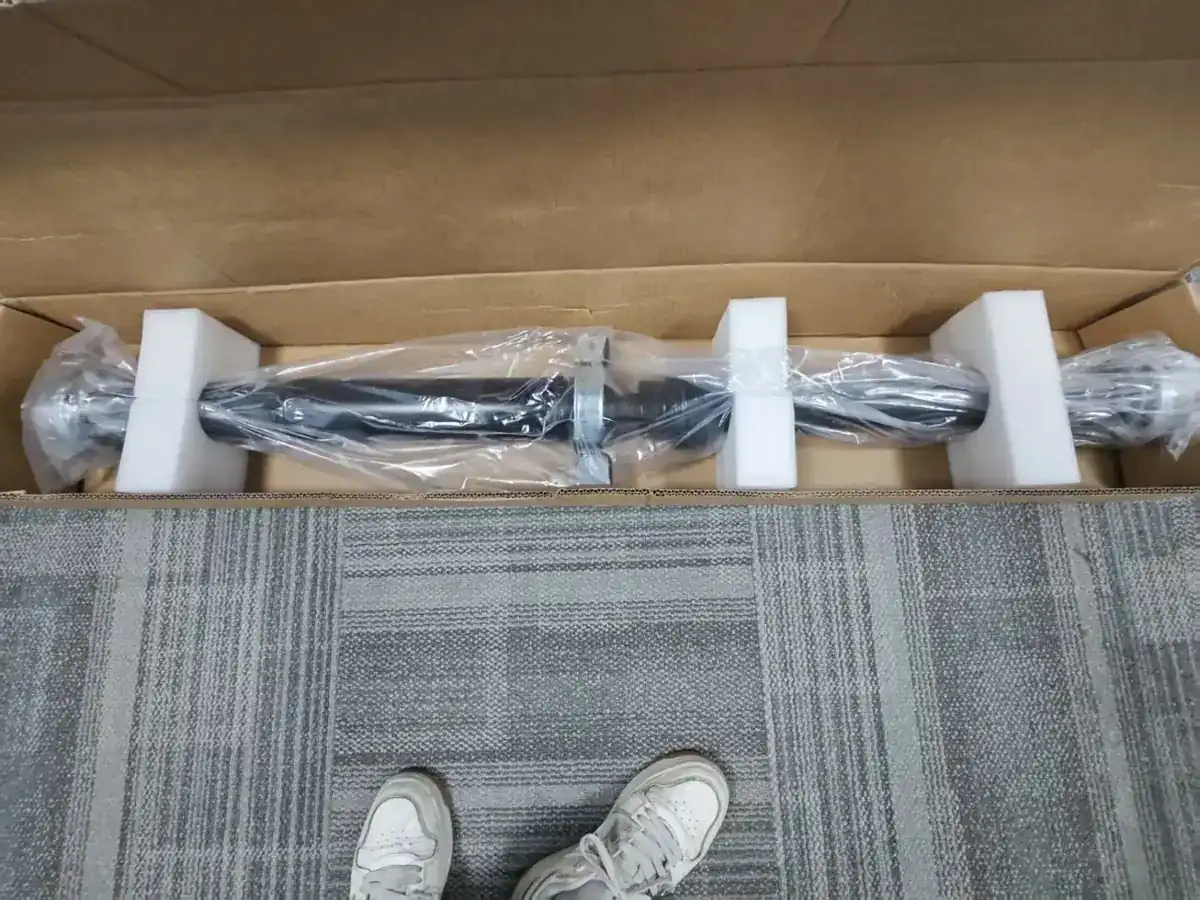 Propeller shafts packed in a wooden crate with foam supports
