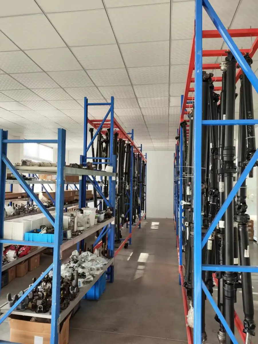 Warehouse racking stocked with boxed replacement parts and shaft assemblies