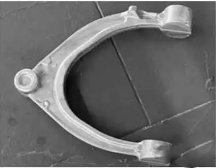Close view of a forged aluminium control arm showing the section profile