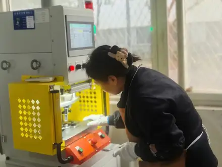 Operator entering a programme at the control panel of a production machine