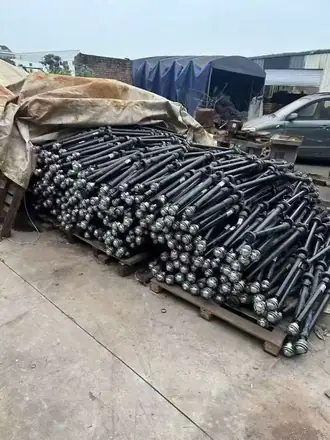 Stack of raw shaft blanks waiting to enter the machining line