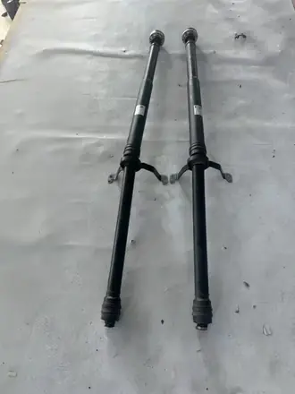 Two propeller shaft assemblies laid out for measurement