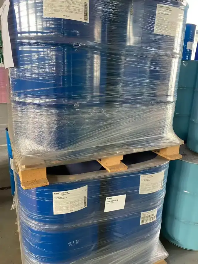 Shrink wrapped pallets of blue epoxy resin drums with grade labels