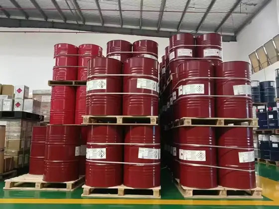 Pallets of red drums of HDI biuret polyisocyanate stacked in a warehouse