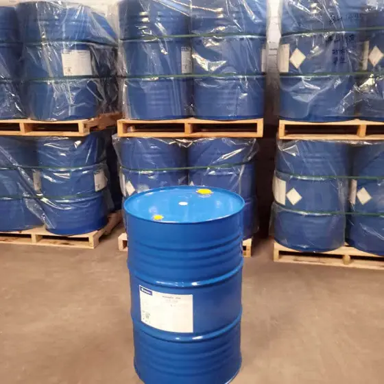 Blue drums of polyetheramine curing agent stacked on pallets in a warehouse