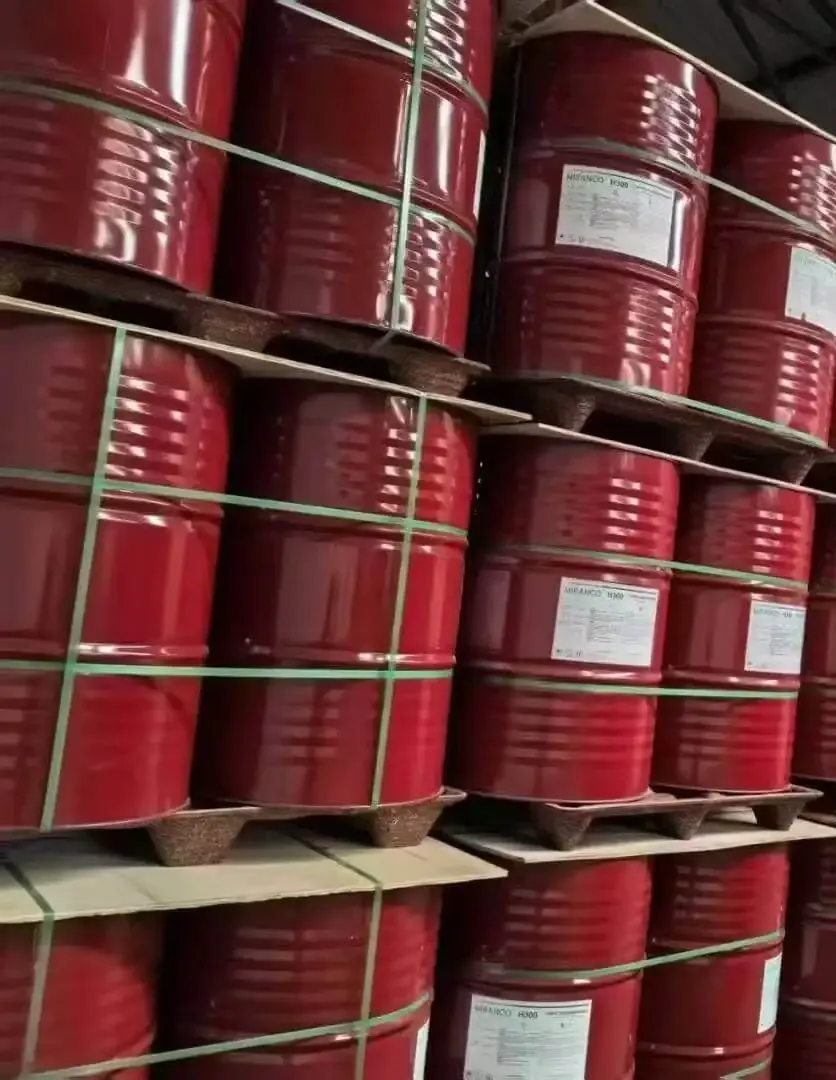 Wall of red steel TDI drums stacked in a bonded chemical warehouse