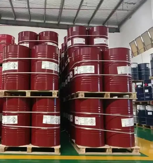 Sealed red steel drums of specialty diisocyanate on pallets in a warehouse