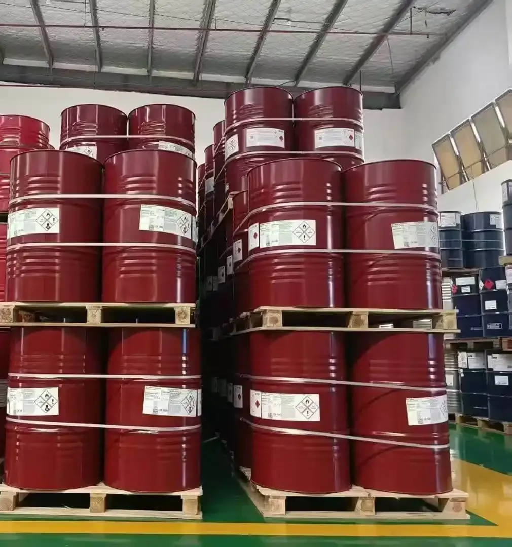 Sealed red steel drums of specialty diisocyanate on pallets in a warehouse