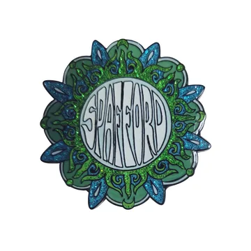 Soft enamel pin with a green leaf border and raised metal lettering