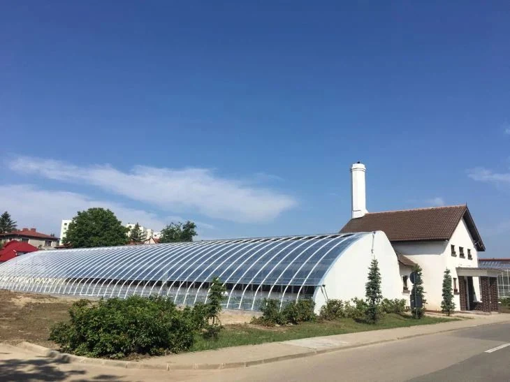 Row of Kunda solar greenhouses built alongside a growing site