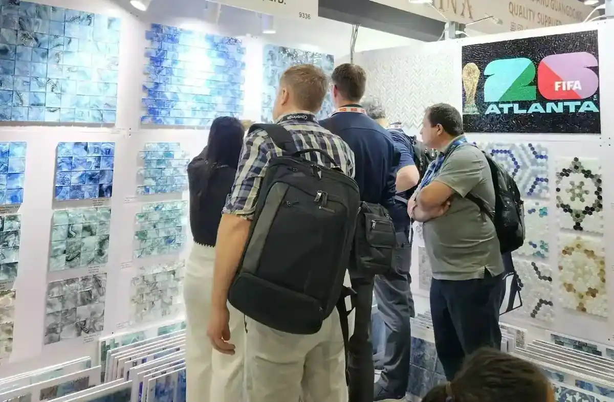 Visitors looking at mosaic sample boards on the LSDECO exhibition stand