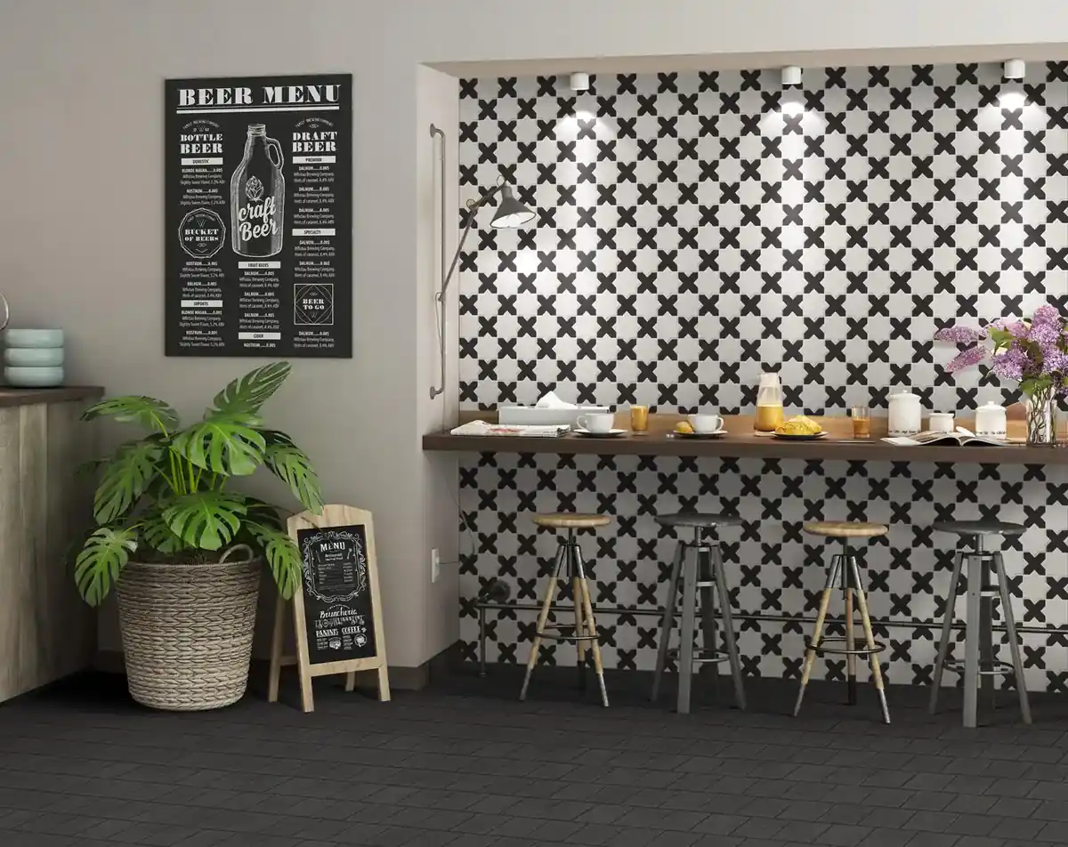 Black and white patterned ceramic tile used as a bar wall in a café interior