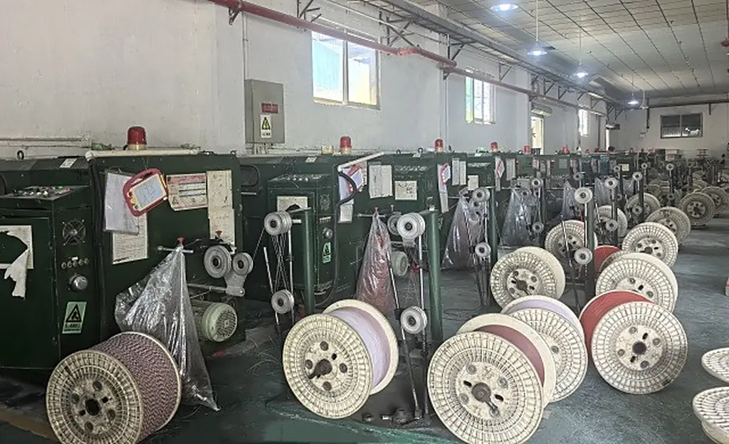 LANP CABLE spooling room with rows of finished cable reels awaiting inspection