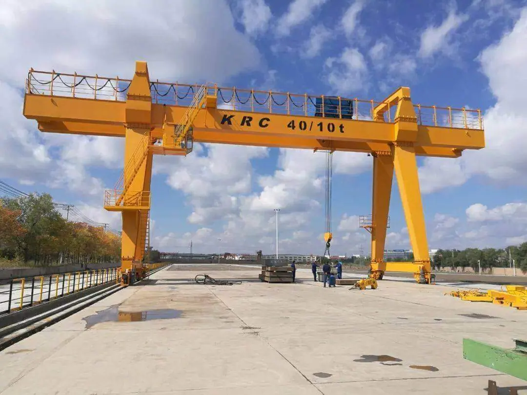 Outdoor gantry crane handling a load in an open yard
