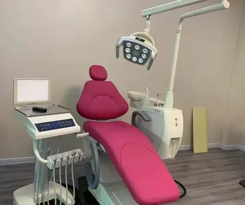 Red dental chair with upholstered cushioning