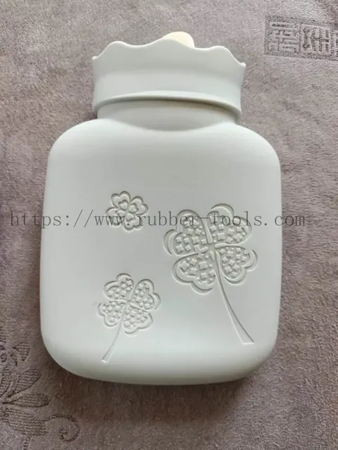 Silicone hot water bag with a green woollen cover