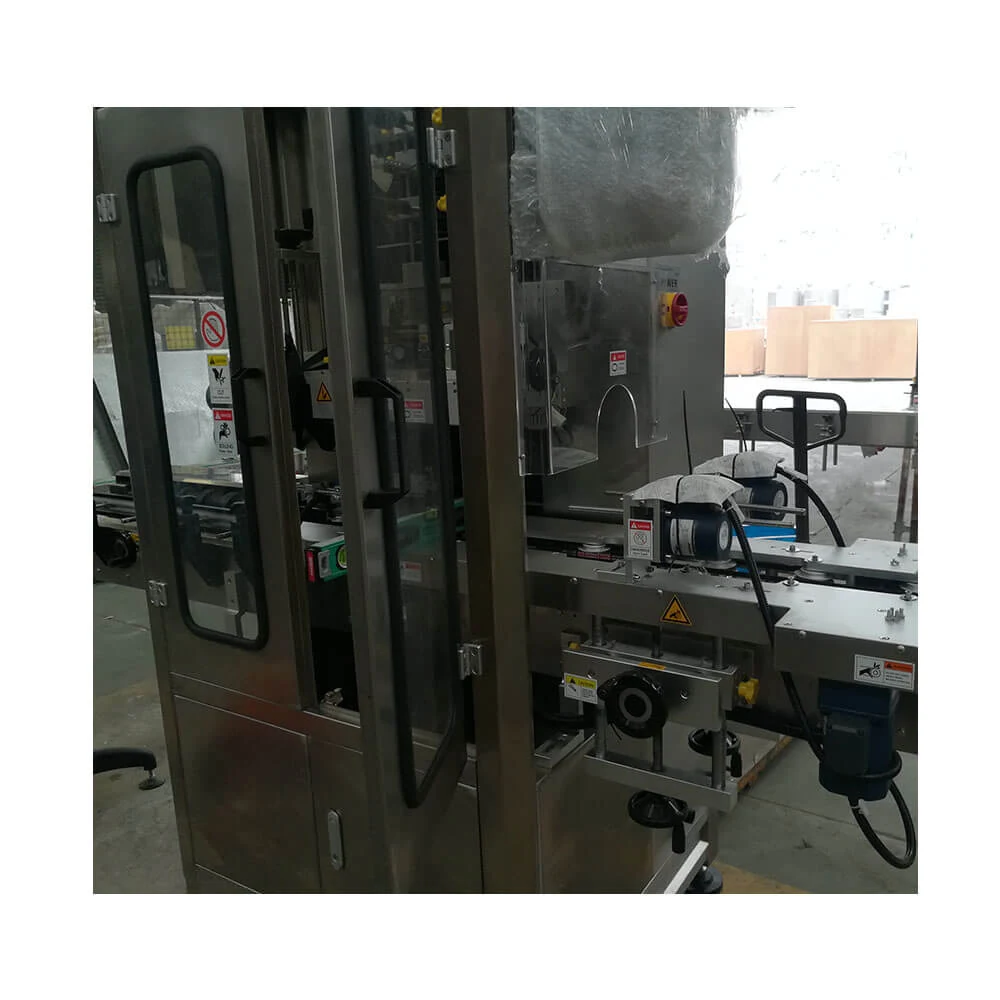 Shrink sleeve labeling machine applying sleeves to bottles