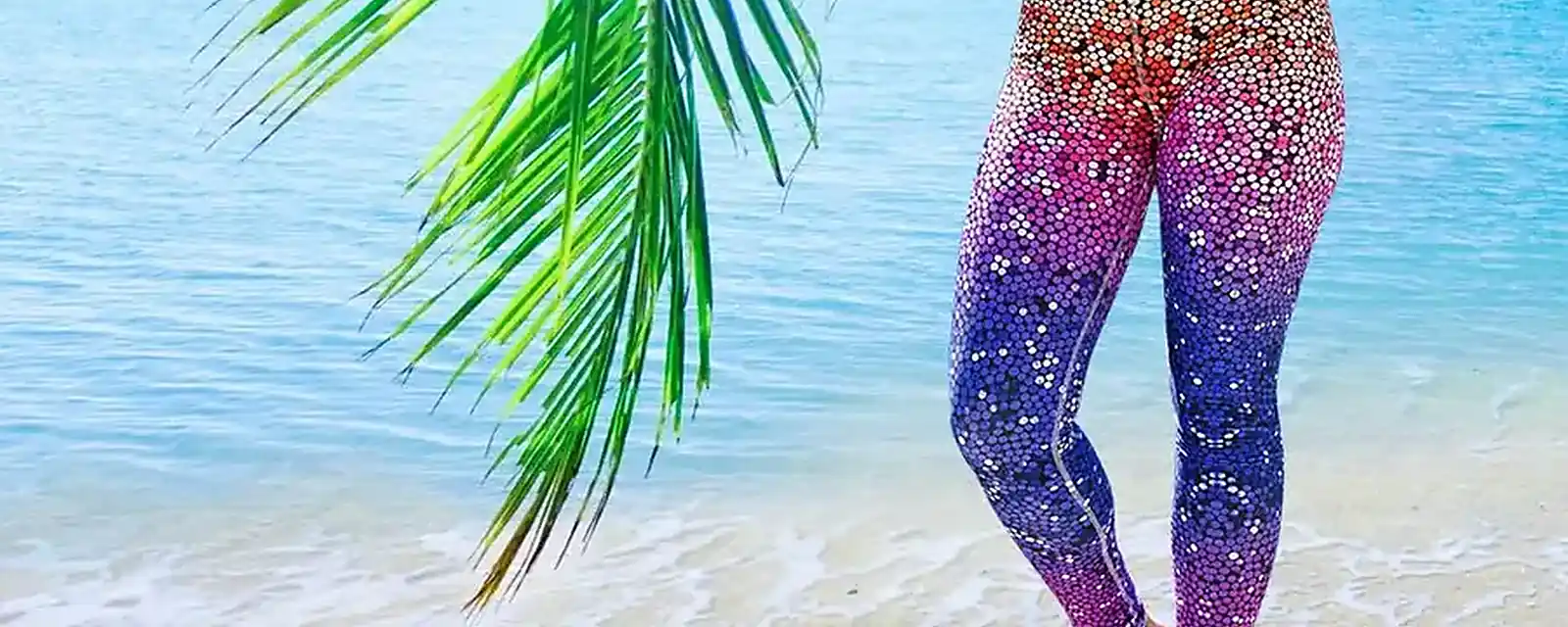 Woman wearing a bright printed legging on a beach