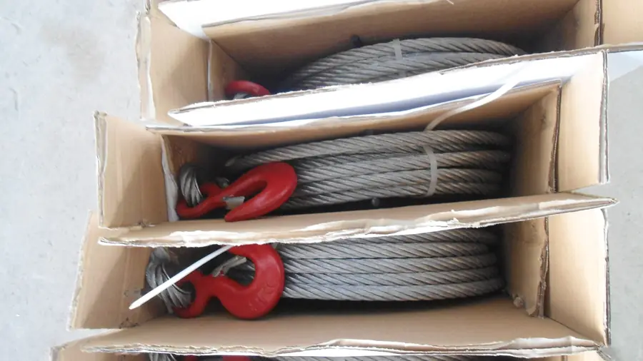 Wire rope pulling hoists with their 20 metre wire ropes packed into cartons before the wooden case