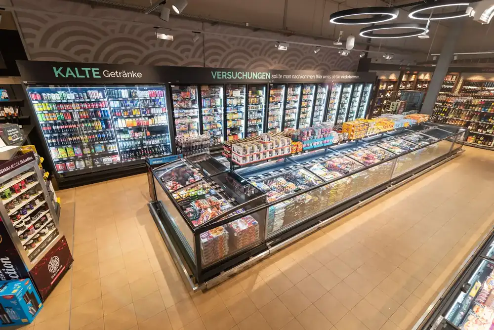 Chilled display counters in a food retail store lit with LED case lighting